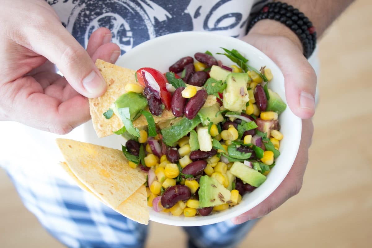 Black Bean Corn Avocado Salad with lime dressing served with homemade tortilla chips