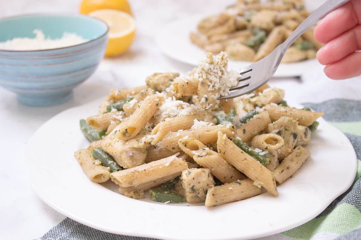 Easy Basil Pesto Chicken Pasta is the perfect HEALTHY weeknight meal for busy days. Packed with flavors and ready under 20 minutes! CLICK to read the recipe or PIN for later. [natalieshealth.com] #recipe #healthy #easy #family #chicken #low-fat #pasta #pesto