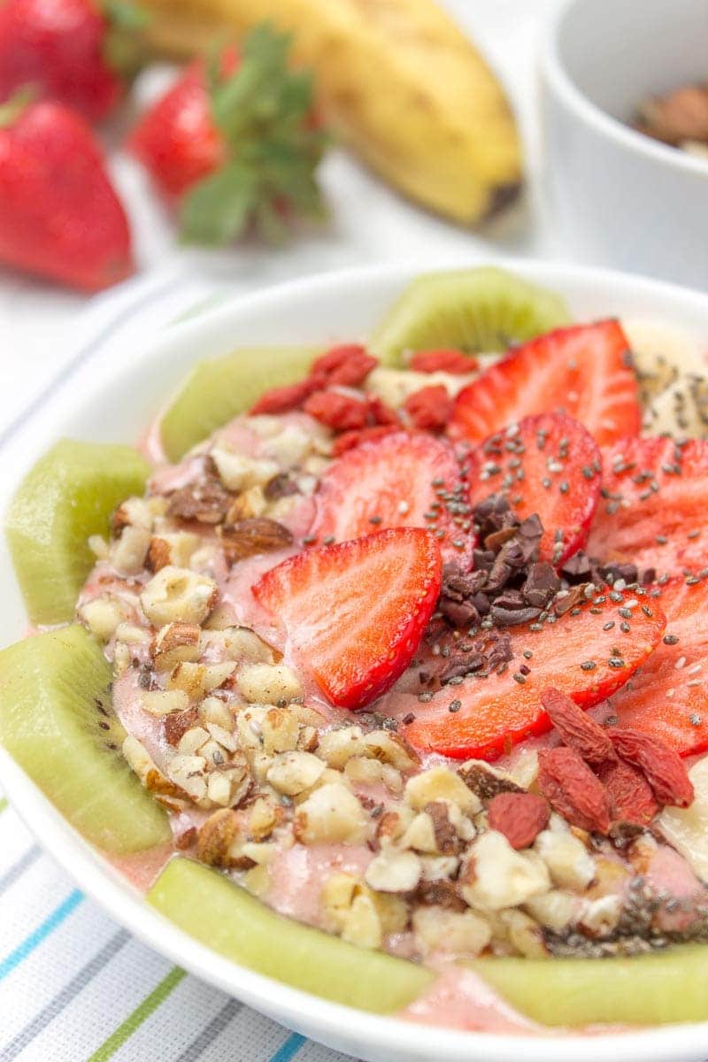 Creamy and sweet with a kick of spicy ginger, this immune boosting Strawberry Ginger Smoothie Bowl is a fresh and HEALTHY breakfast done in just minutes! Packed with nutrients, low calorie and WITHOUT added sugars. Vegan, gluten free and dairy free. DELICIOUS! #vegan #glutenfree #dairyfree #sugarfree #healthy #smoothie #recipe #breakfast #kids