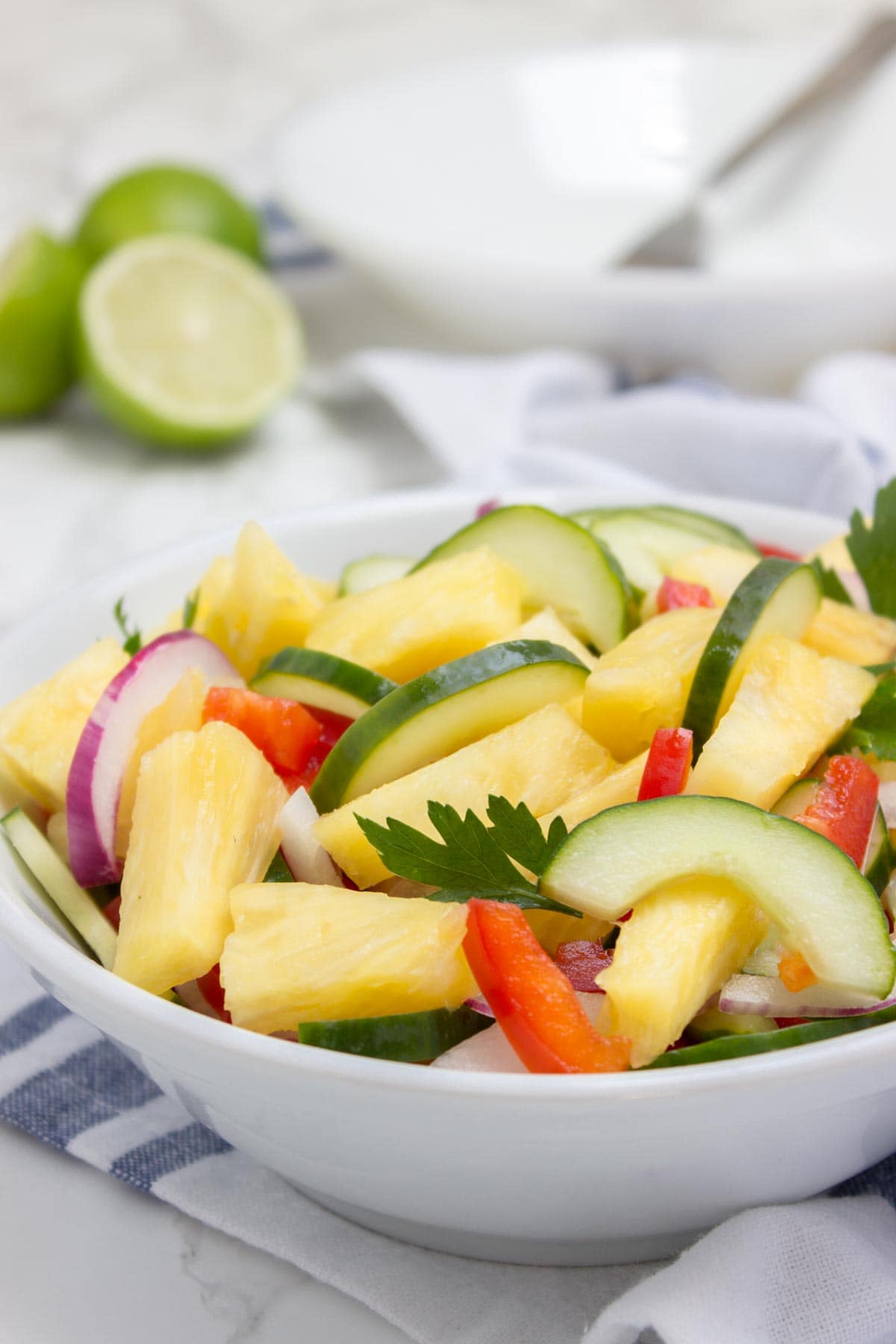 Jucy and refreshing Pineapple Cucumber Salad is a super HEALTHY way to cool down this summer! This salad is easy to make, bursting with fresh summer flavors and full of nutrients. Perfect side for summer BBQs and parties! #summer #BBQ #picnic #party #glutenfree #vegan #salad #healthy #lowcalorie #weightloss #fit #kidsfriendly | natalieshealth.com