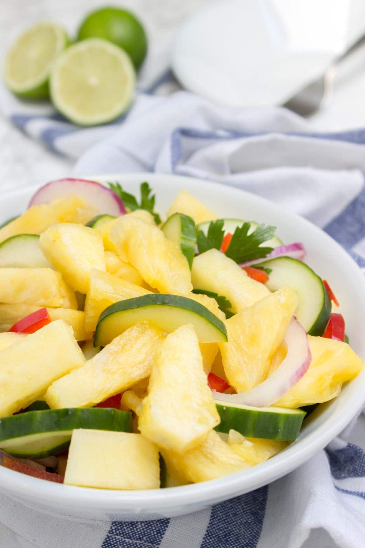 Jucy and refreshing Pineapple Cucumber Salad is a super HEALTHY way to cool down this summer! This salad is easy to make, bursting with fresh summer flavors and full of nutrients. Perfect side for summer BBQs and parties! #summer #BBQ #picnic #party #glutenfree #vegan #salad #healthy #lowcalorie #weightloss #fit #kidsfriendly | natalieshealth.com