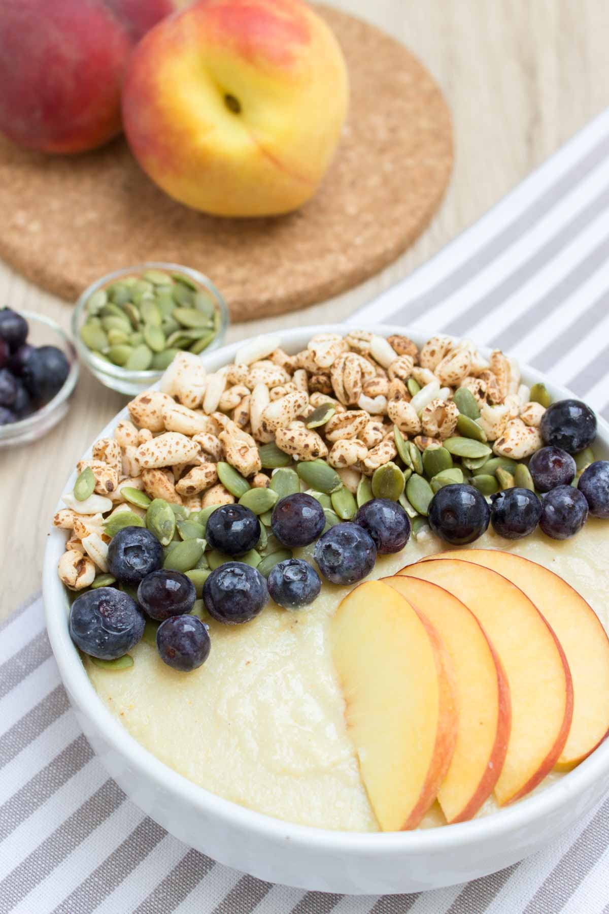 Thick, creamy and irresistible sweet Pineapple Peach Smoothie Bowl is a perfect weekend breakfast. It's packed with healthy fibers, vitamins, plant based proteins, and HEALTHY omega-3. It's an easy way to turn a healthy smoothie into a whole meal. #vegan #glutenfree #sugarfree #paleo #sugarfree #healthy #dairyfree #smoothie #breakfast #kidsfriendly #snack #whole30 | natalieshealth.com