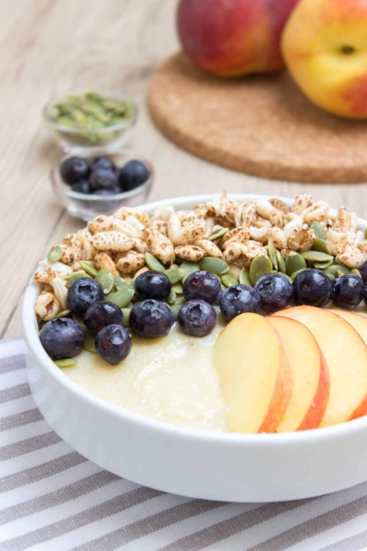 Thick, creamy and irresistible sweet Pineapple Peach Smoothie Bowl is a perfect weekend breakfast. It's packed with healthy fibers, vitamins, plant based proteins, and HEALTHY omega-3. It's an easy way to turn a healthy smoothie into a whole meal. #vegan #glutenfree #sugarfree #paleo #sugarfree #healthy #dairyfree #smoothie #breakfast #kidsfriendly #snack #whole30 | natalieshealth.com