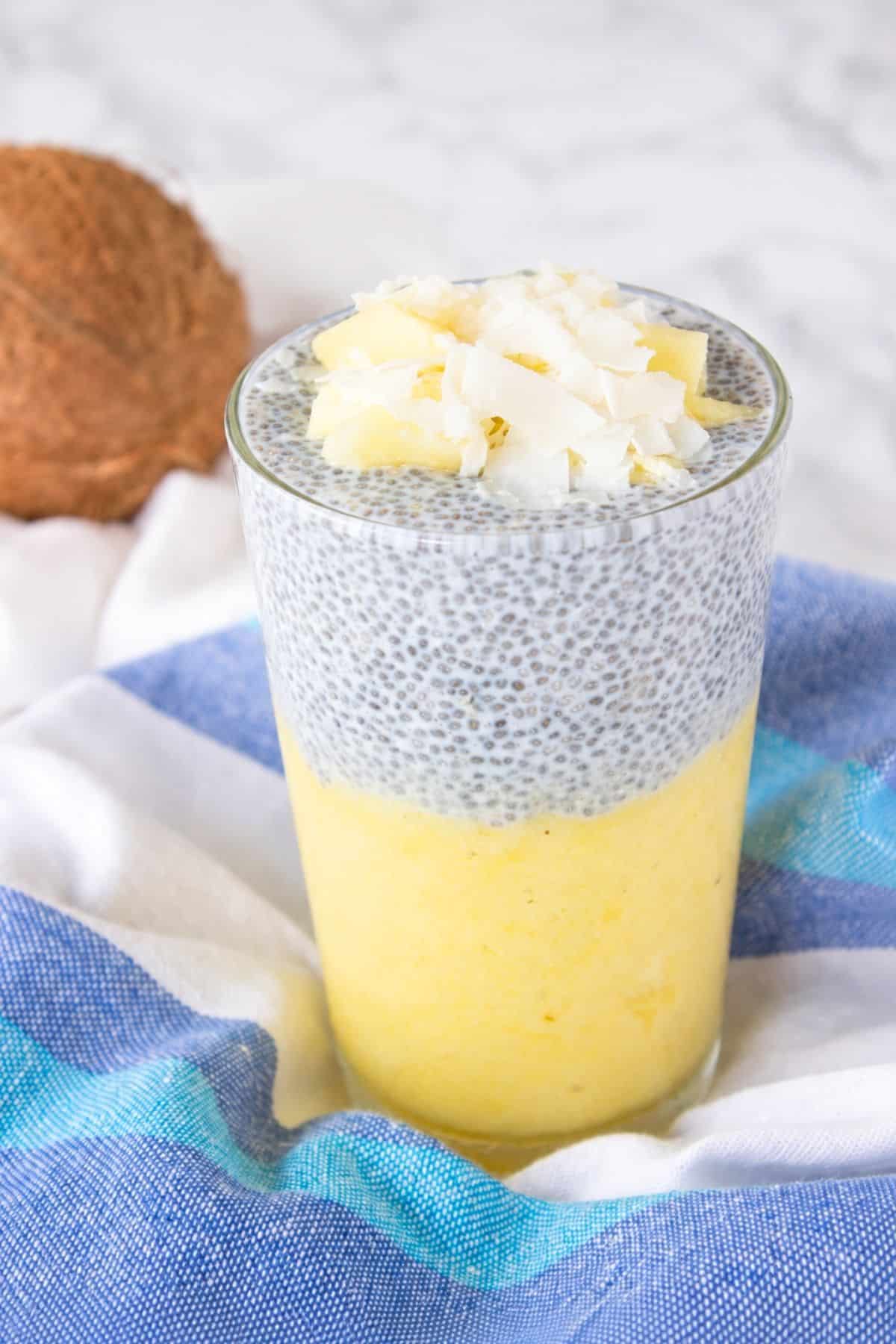 Pineapple Coconut Chia Pudding layered with pineapple puree and topped with fresh pineapple and coconut flakes