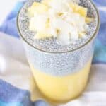 Pineapple coconut chia pudding layered with pineapple puree and topped with fresh pineapple and coconut flakes