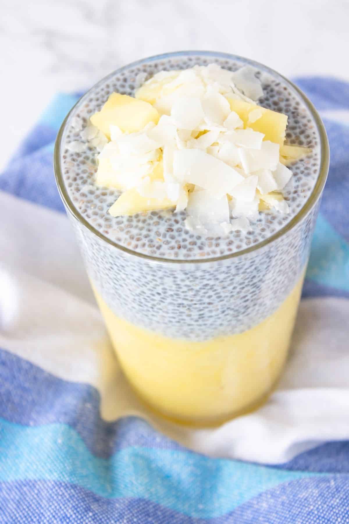 Pineapple Coconut Chia Pudding layered with pineapple puree and topped with fresh pineapple and coconut flakes