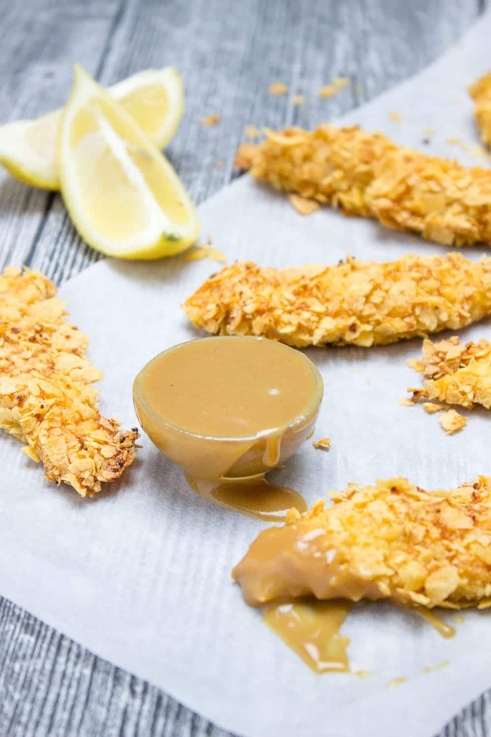 Crispy Baked Cornflake Chicken Tenders made without added fat are the perfect low-calorie, quick and HEALTHY family meal. Served with homemade Honey Dijon Sauce, these tenders are delicious gameday finger food too. CLICK to read more or PIN for later! 