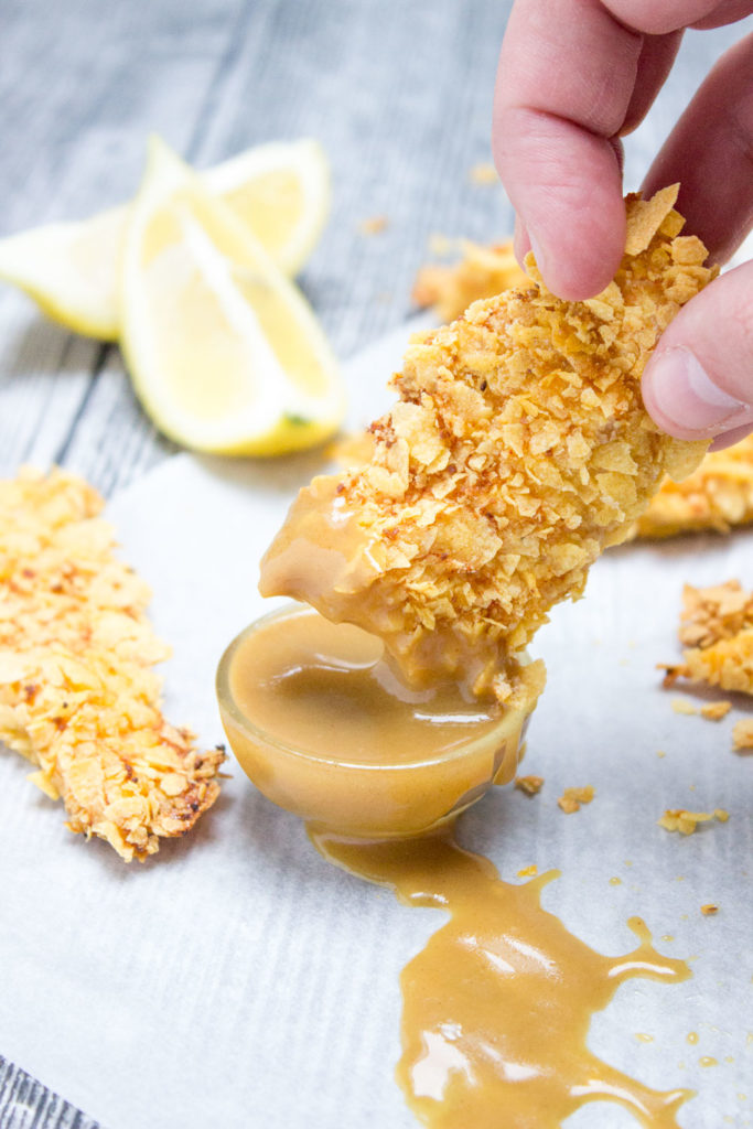 Crispy Baked Cornflake Chicken Tenders made without added fat are the perfect low-calorie, quick and HEALTHY family meal. Served with homemade Honey Dijon Sauce, these tenders are delicious gameday finger food too. CLICK to read more or PIN for later!