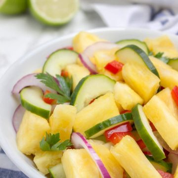 Juicy and refreshing Pineapple Cucumber Salad is a super HEALTHY way to cool down this summer! This salad is easy to make, bursting with fresh summer flavors and full of nutrients. Perfect side for summer BBQs and parties! #summer #BBQ #picnic #party #glutenfree #vegan #salad #healthy #lowcalorie #weightloss #fit #kidsfriendly | natalieshealth.com