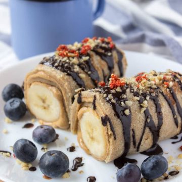 Chocolate Peanut Butter Banana Roll-Ups with crepes peanut butter and bananas drizzled with raw chocolate.