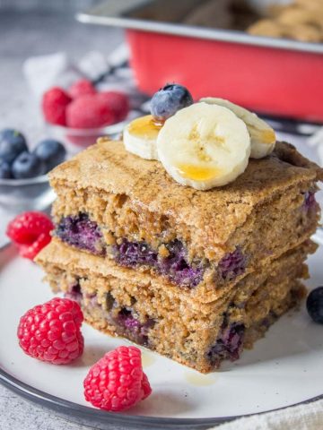 Healthy oven baked Blueberry Pancake Casserole topped with banana and raspberries