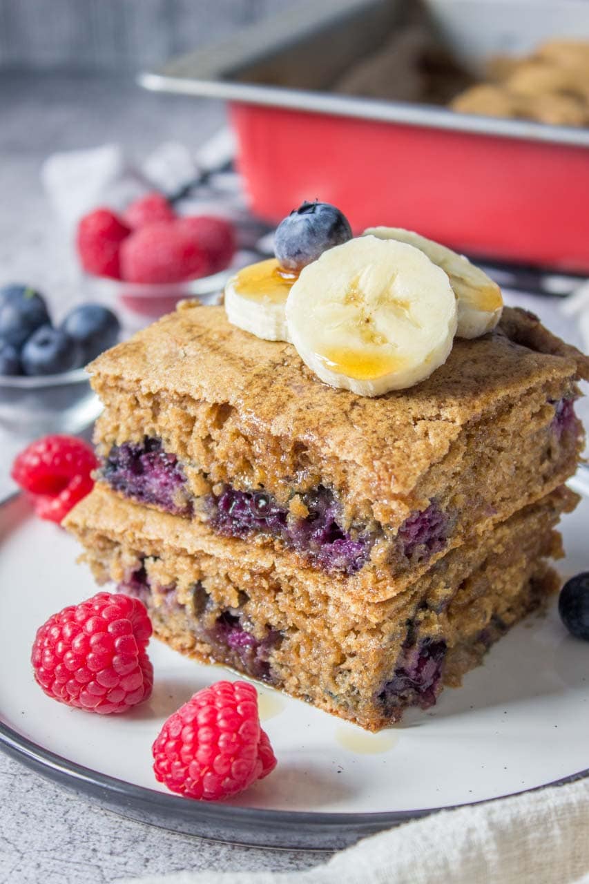 Healthy oven baked Blueberry Pancake Casserole topped with banana and raspberries