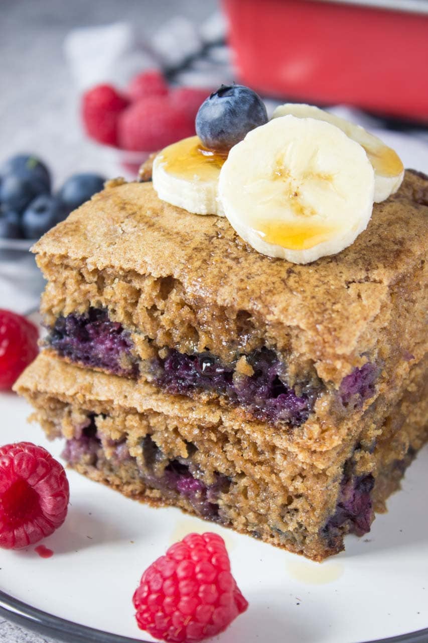 Healthy oven baked Blueberry Pancake Casserole topped with banana and raspberries