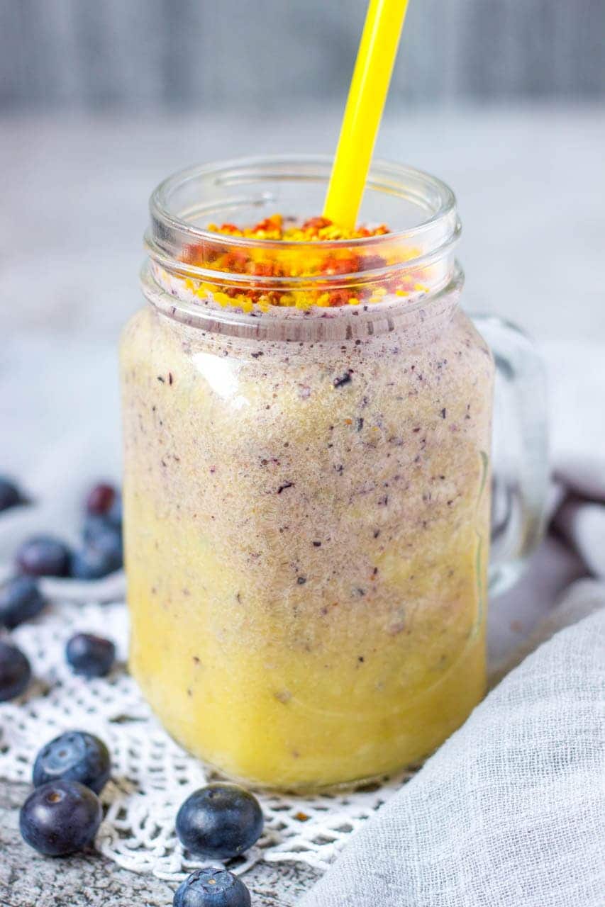 Mango Blueberry Smoothie topped with goji berries and bee pollen