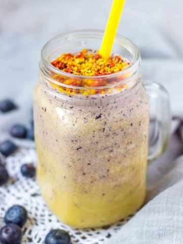 Mango Blueberry Smoothie topped with goji berries and bee pollen