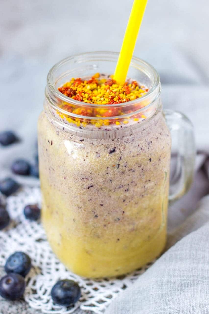 Mango Blueberry Smoothie topped with goji berries and bee pollen