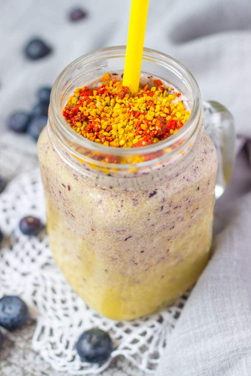 Mango Blueberry Smoothie topped with goji berries and bee pollen