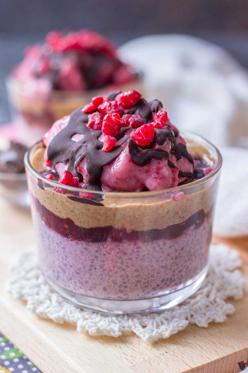 Raspberry Chia Pudding with almond butter and raspberry jam topped with banana raspberry ice cream and chocolate