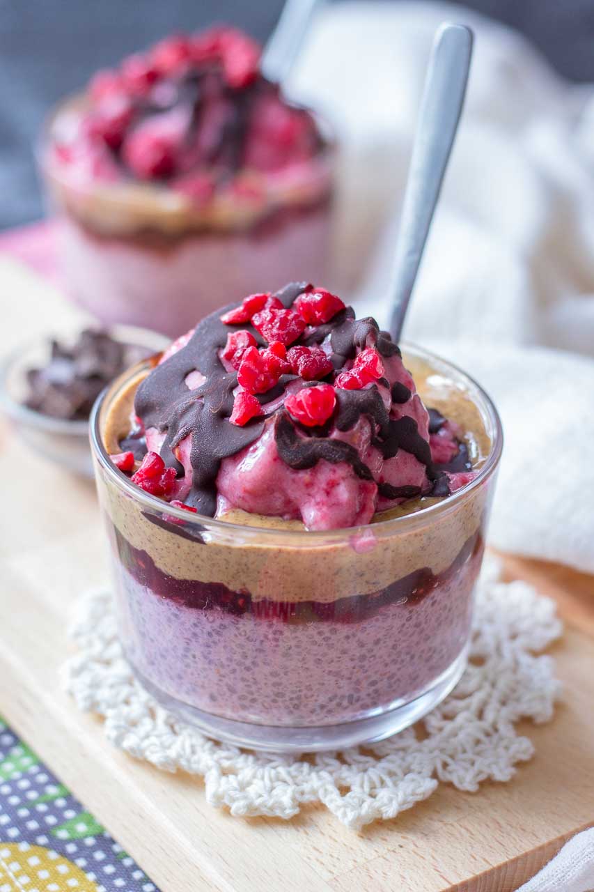 Raspberry Chia Pudding with almond butter and raspberry jam topped with banana raspberry ice cream and chocolate