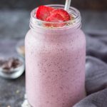 Strawberry Kefir Smoothie topped with fresh strawberries and superfoods