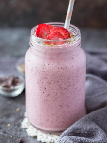 Strawberry Kefir Smoothie topped with fresh strawberries and superfoods