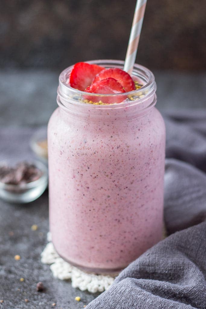 Strawberry Kefir Smoothie topped with fresh strawberries and superfoods