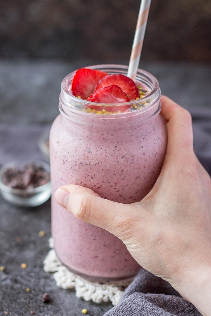 Strawberry Kefir Smoothie topped with fresh strawberries and superfoods