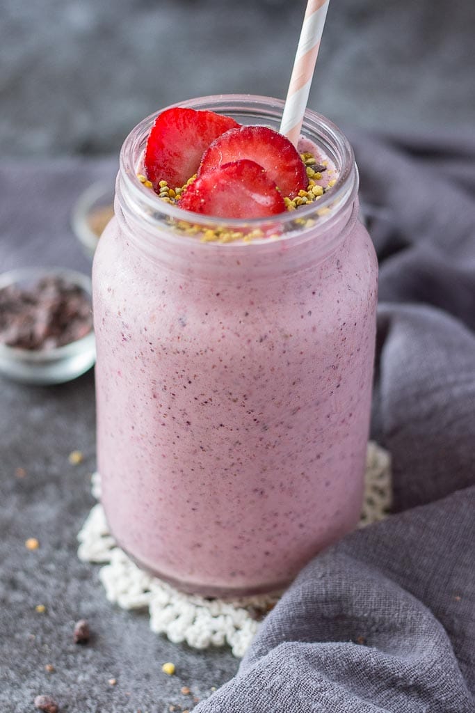 Strawberry Kefir Smoothie topped with fresh strawberries and superfoods