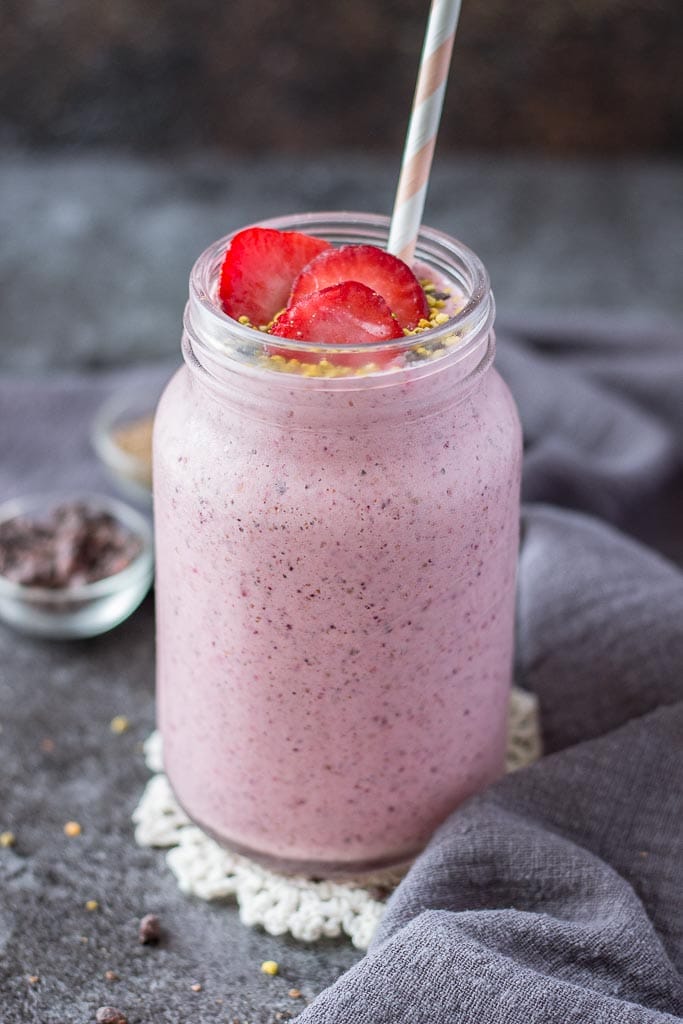 Strawberry Kefir Smoothie topped with fresh strawberries and superfoods