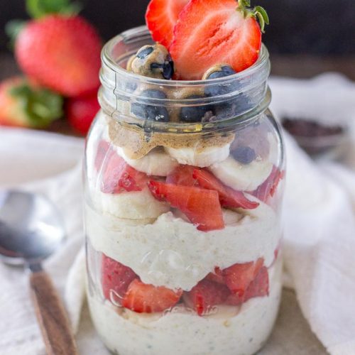 Strawberry overnight oats with yogurt topped with banana and almond butter