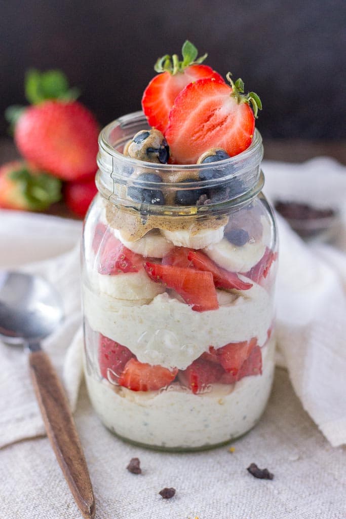 Strawberry overnight oats with yogurt topped with banana and almond butter