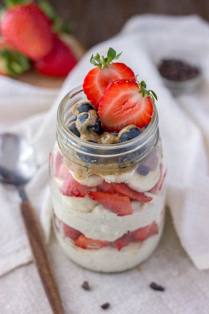 Strawberry overnight oats with yogurt topped with banana and almond butter