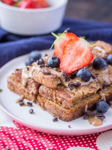 Healthy Cinnamon French Toast made with whole grain toast topped with almond butter and fruits