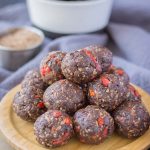 Chocolate Prune Energy Balls served on a wooden plate
