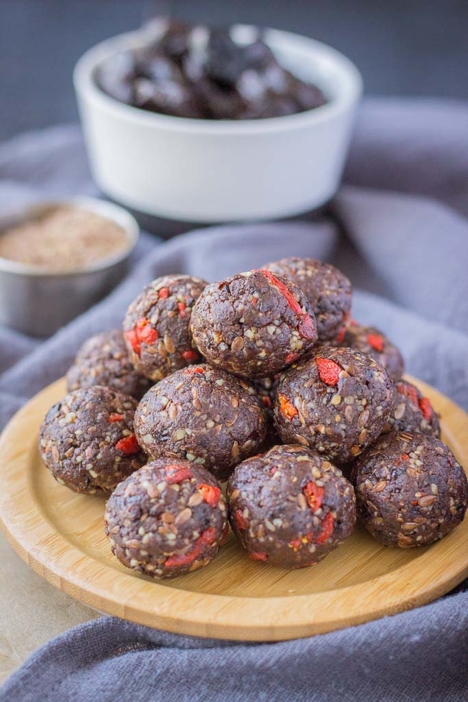 Chocolate Prune Energy Balls served on a wooden plate