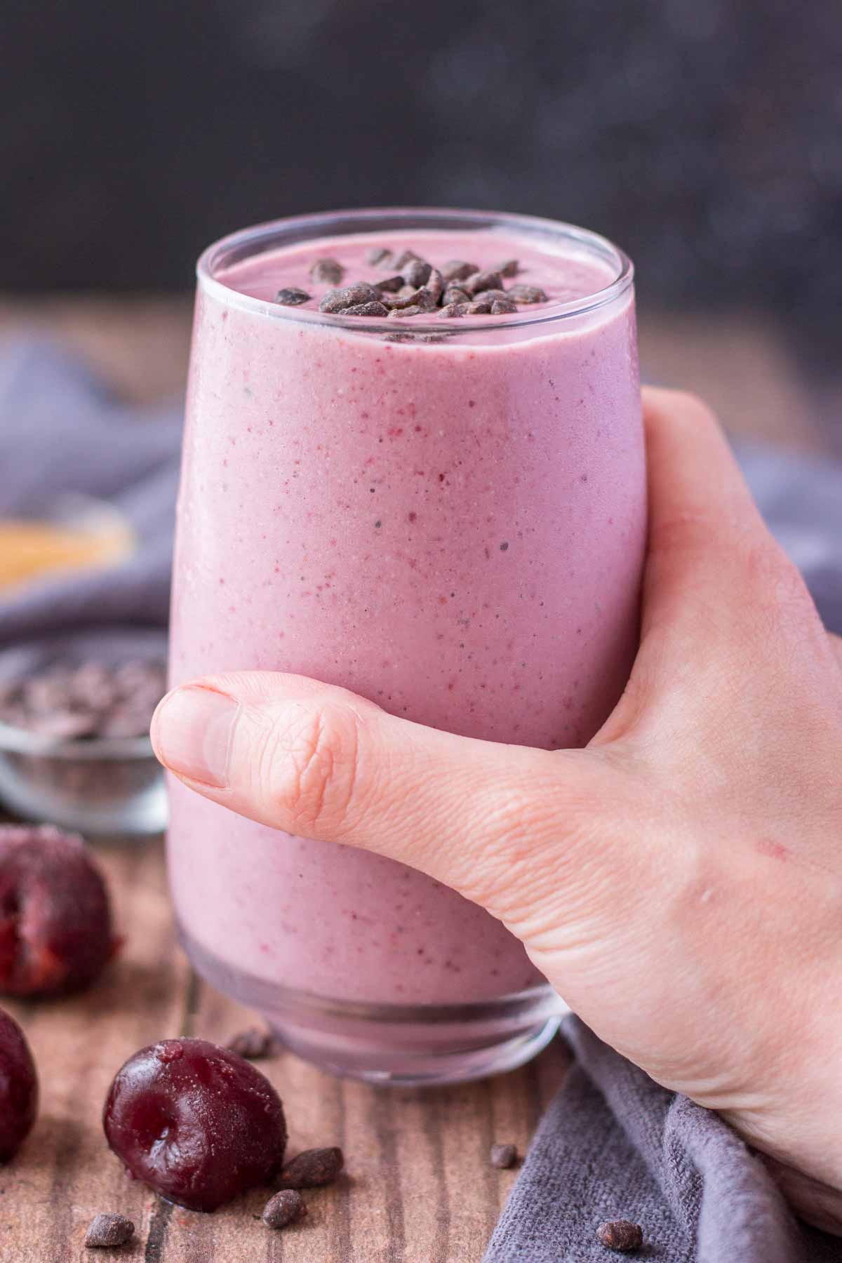 Hand holding a Cherry Banana Smoothie