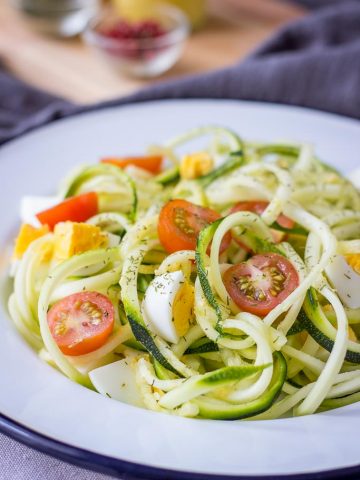 Zucchini Noodle Salad with hard-boiled eggs cherry tomatoes and mustard flaxseed oil vinaigrette
