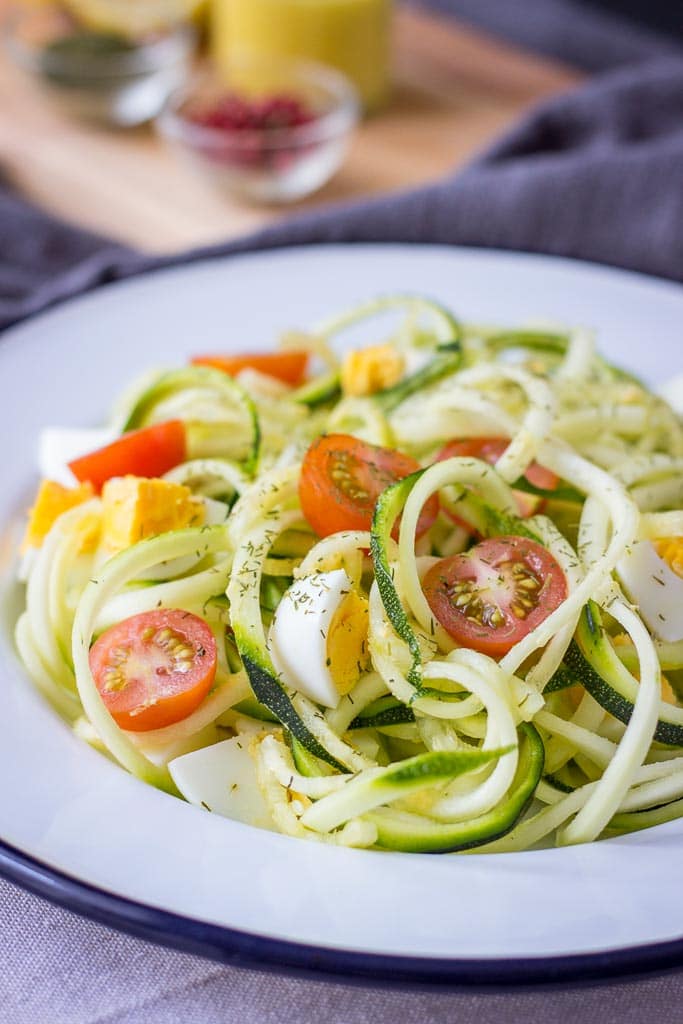 Zucchini Noodle Salad with hard-boiled eggs cherry tomatoes and mustard flaxseed oil vinaigrette