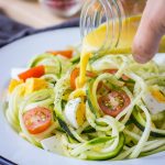 Zucchini Noodle Salad with hard-boiled eggs cherry tomatoes and mustard flaxseed oil vinaigrette