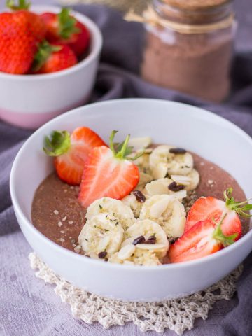 Chocolate oatmeal served with fresh strawberries and banana