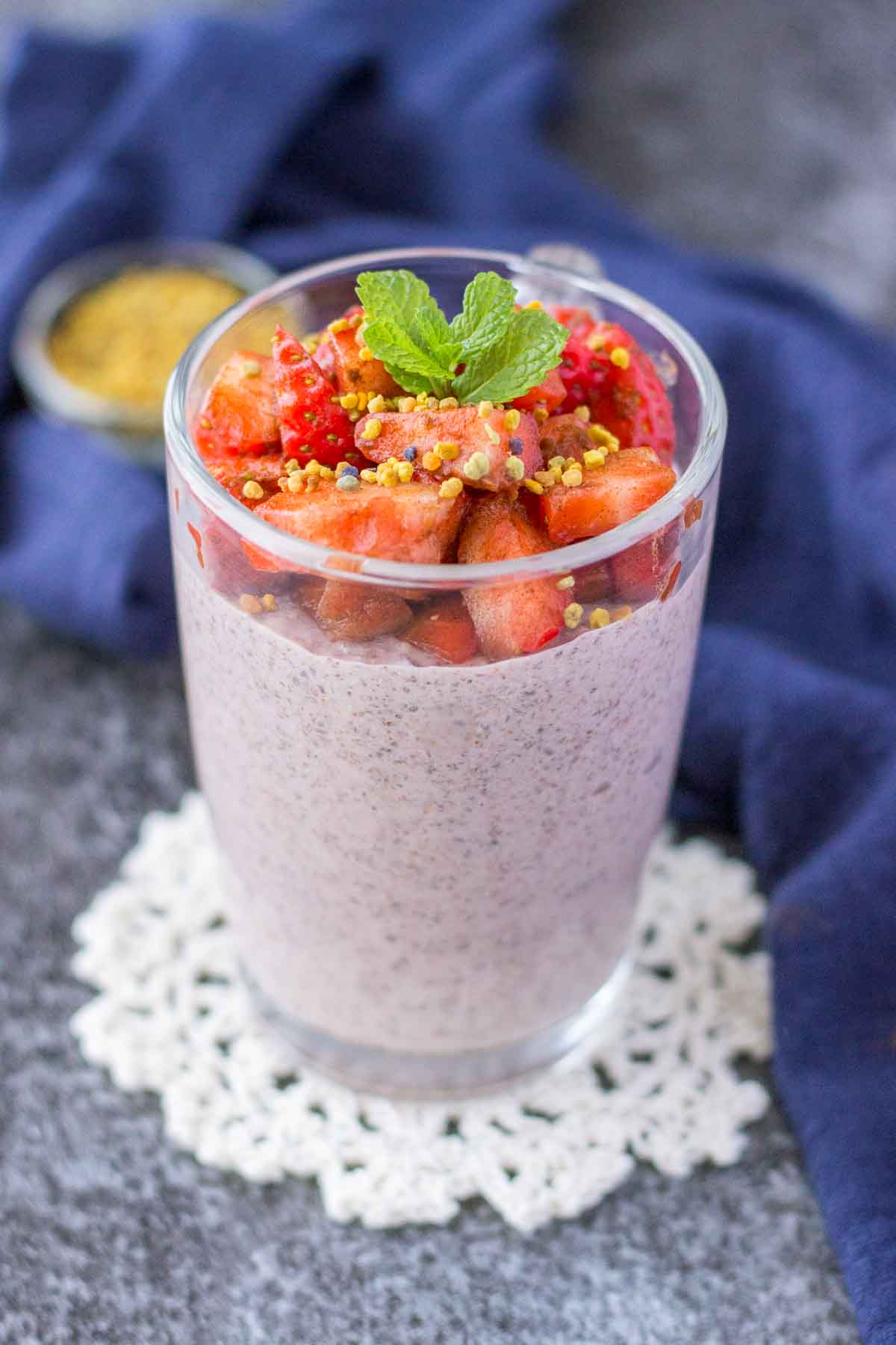 Strawberry Chia Pudding served in a glass jar topped with fresh strawberries
