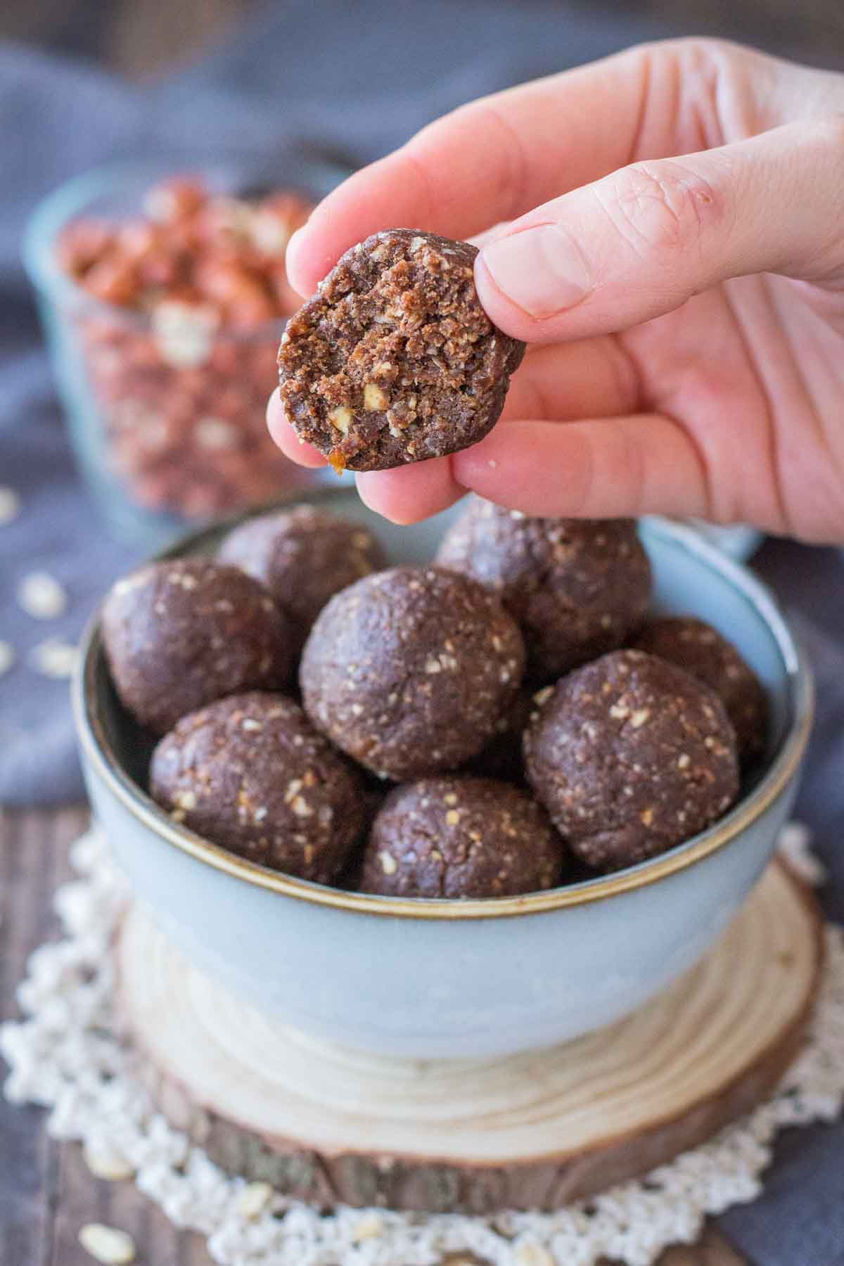Hand taking Chocolate Peanut Butter Balls from a bowl