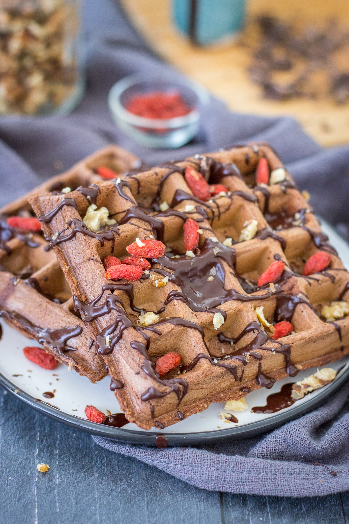 Chocolate waffles served on a plate drizzled with melted chocolate