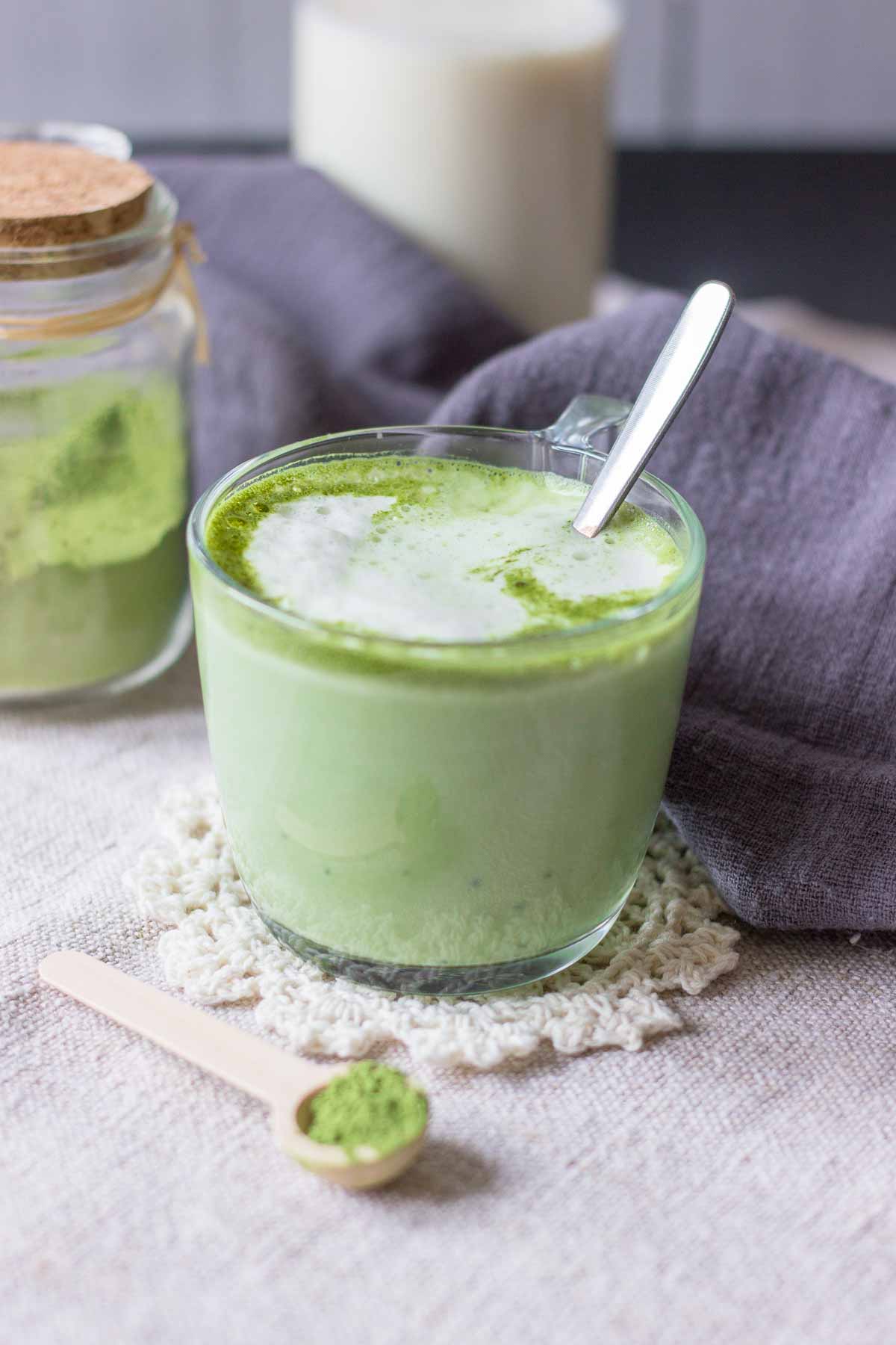 Matcha latte served in a mug with a spoon