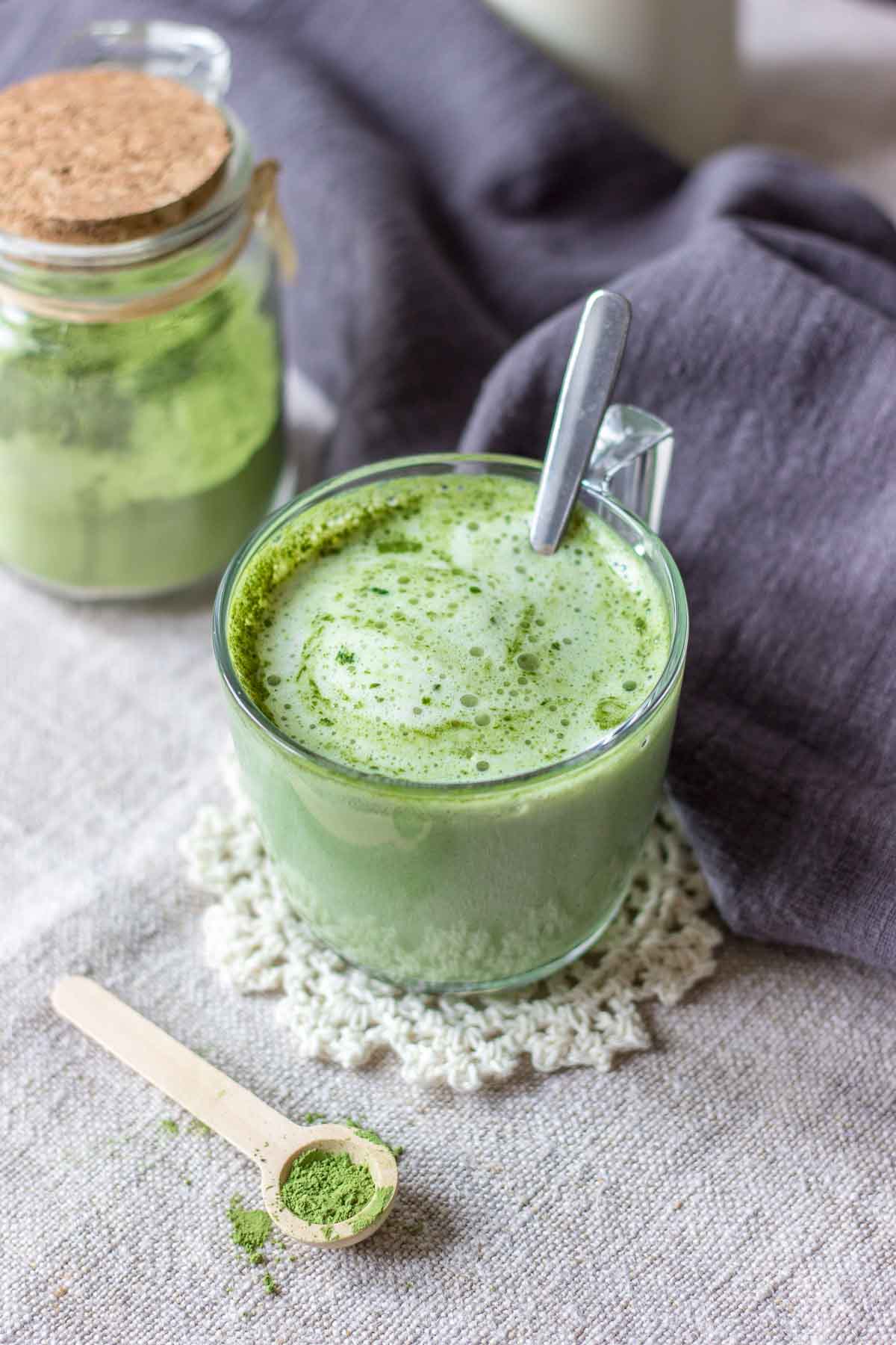 Matcha latte served in a mug with a spoon