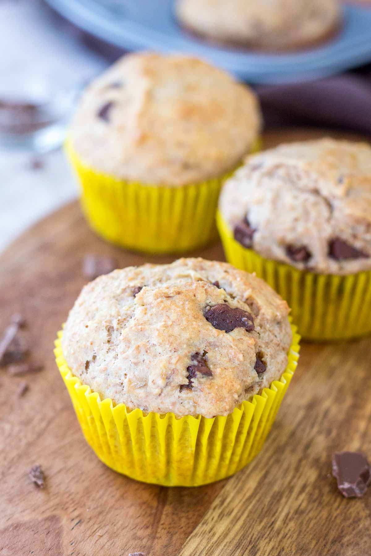 Chocolate Chip Banana Muffins served on a wooden plate.