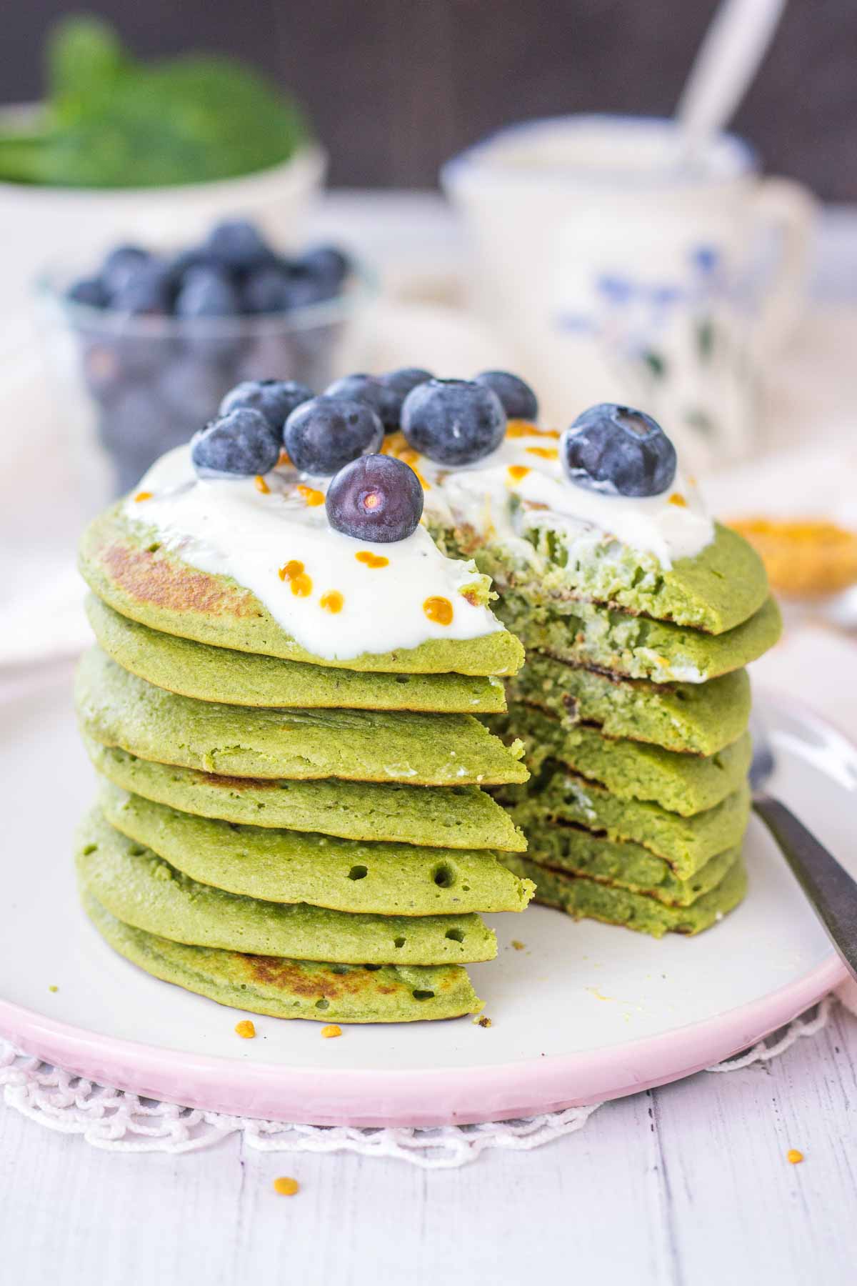 Matcha Pancakes topped with yogurt and blueberries.