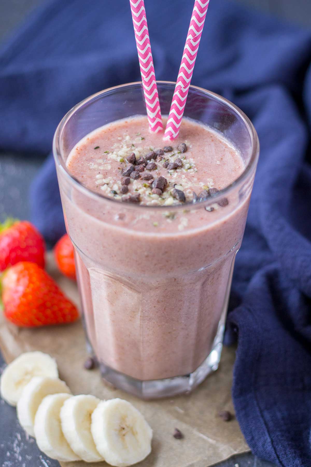 Strawberry Banana Smoothie served in a glass toped with banana slices and chocolate