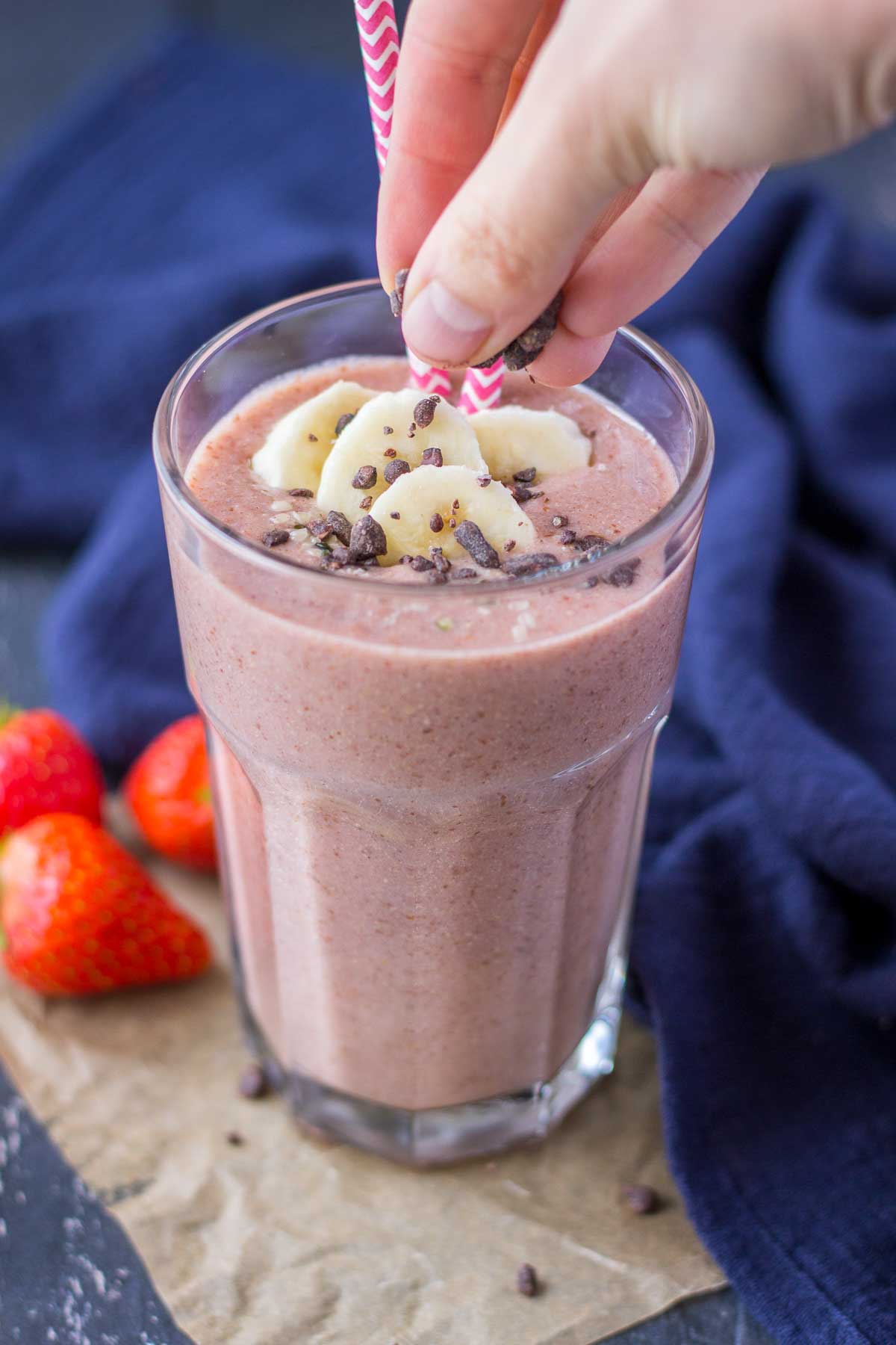 Strawberry Banana Smoothie served in a glass toped with banana slices and chocolate