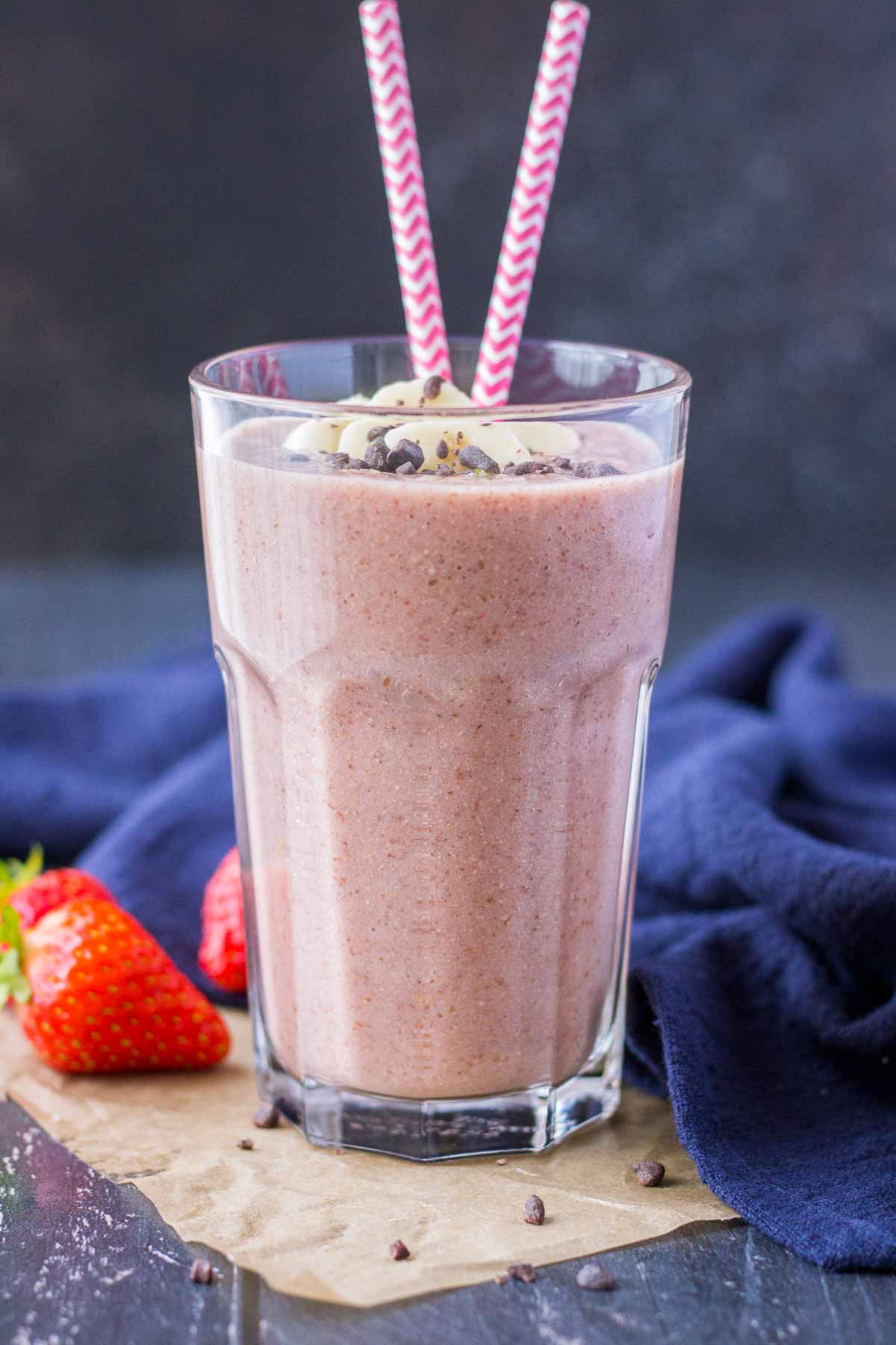 Strawberry Banana Smoothie served in a glass toped with banana slices and chocolate